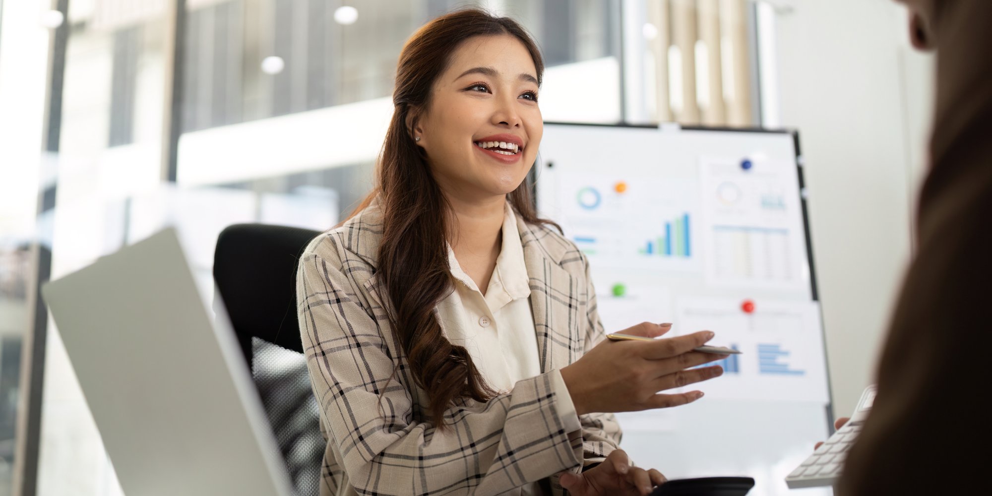 A woman talking to a man in an office