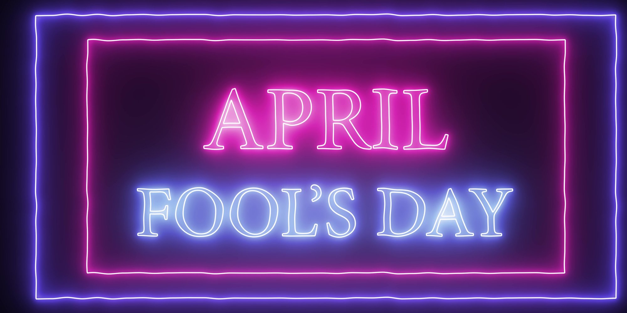 The words APRIL FOOL'S DAY are displayed in neon lights, with APRIL in pink and FOOL'S DAY in blue, surrounded by a rectangular neon border of pink and blue lights against a dark background.